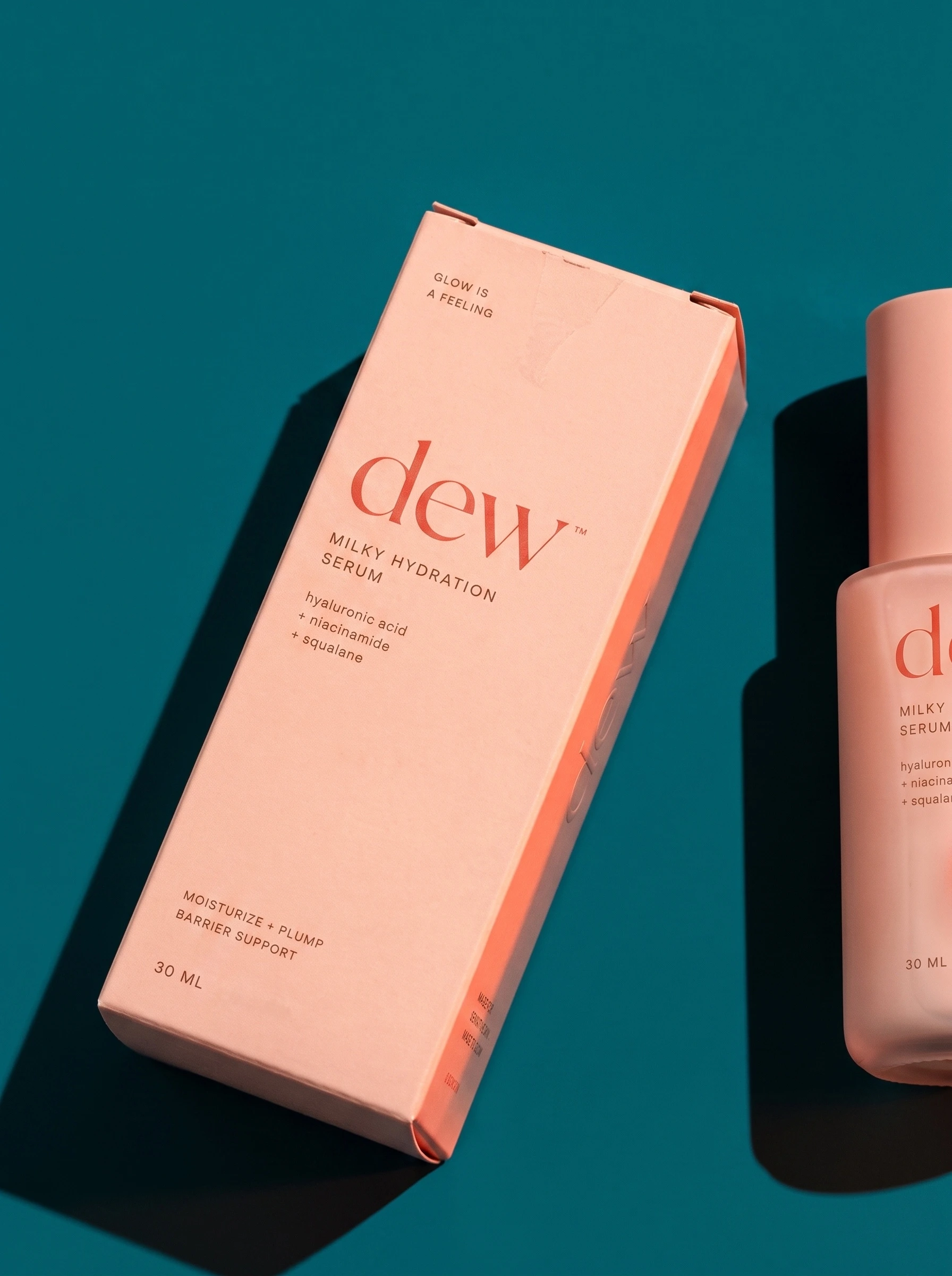Printed serum carton in pink, beside the bottle it holds